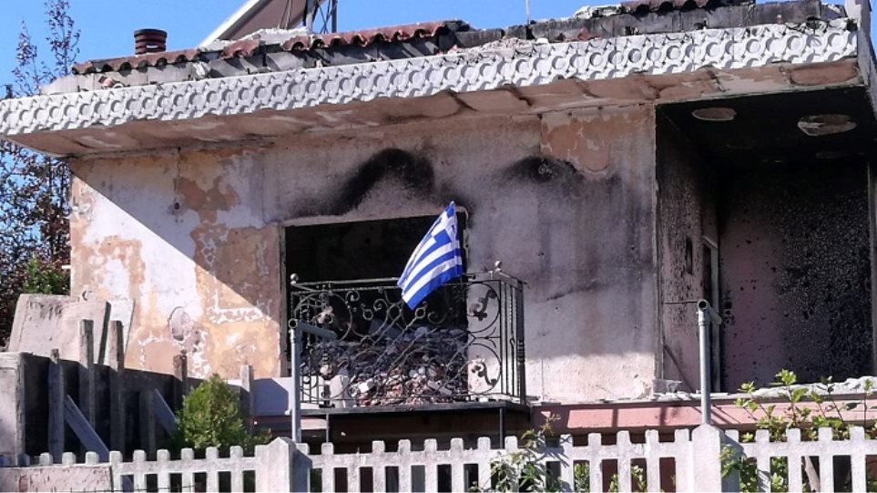 Ύψωσε την ελληνική σημαία στα αποκαΐδια του σπιτιού της στο Μάτι (Photo)  - Media